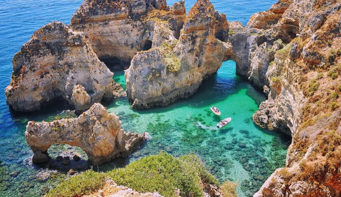 See the rugged cliffs in the Algarve