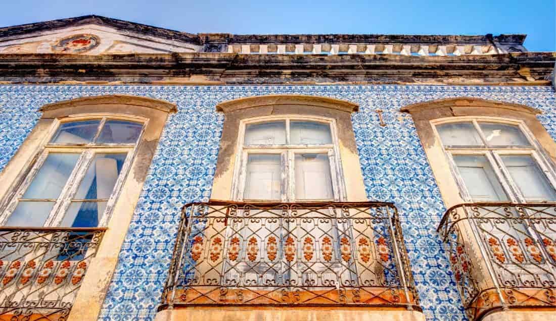 See the colourful buildings of Tavira