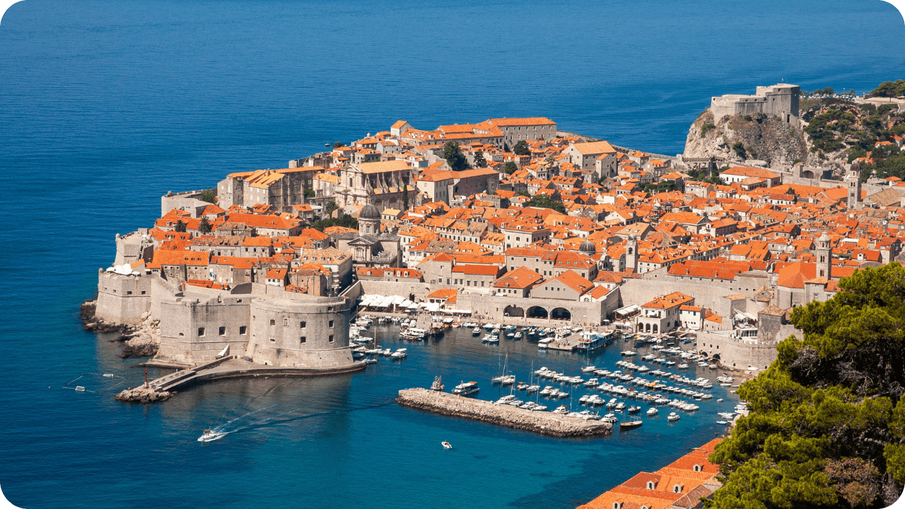 The image shows the city of Dubrovnik, a historic city in Croatia located on the Adriatic Sea. Often referred to as the "Pearl of the Adriatic," the city is known for its distinctive Old Town, which is a UNESCO World Heritage Site. 