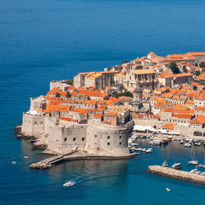the coastal city of Dubrovnik, known for its historic walled Old Town and red-roofed buildings