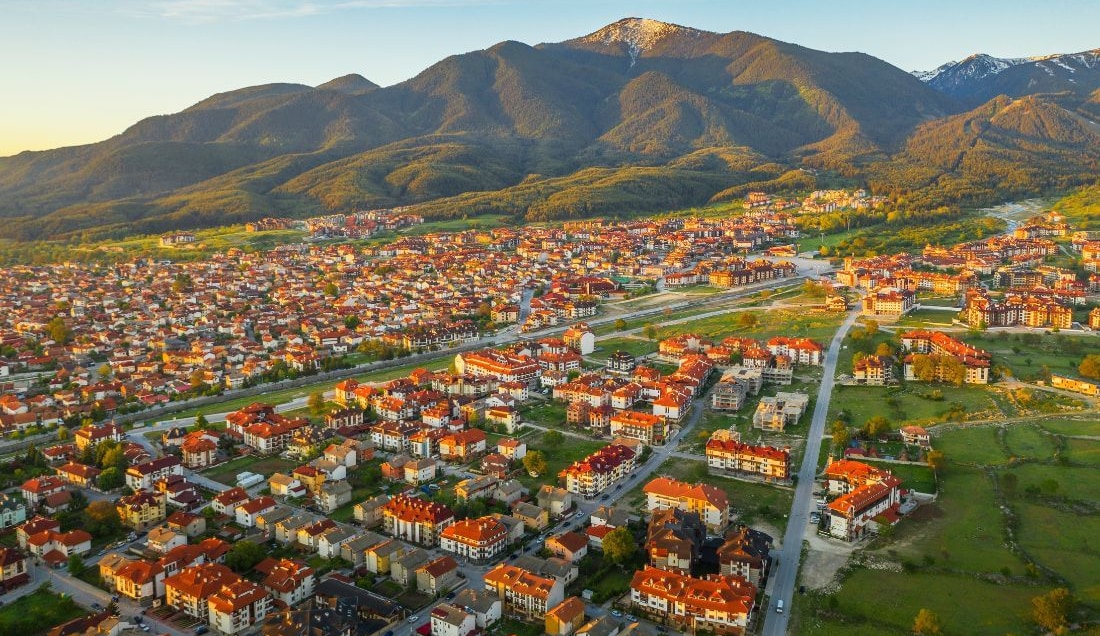 Stay in Bansko, a charming mountain town. 