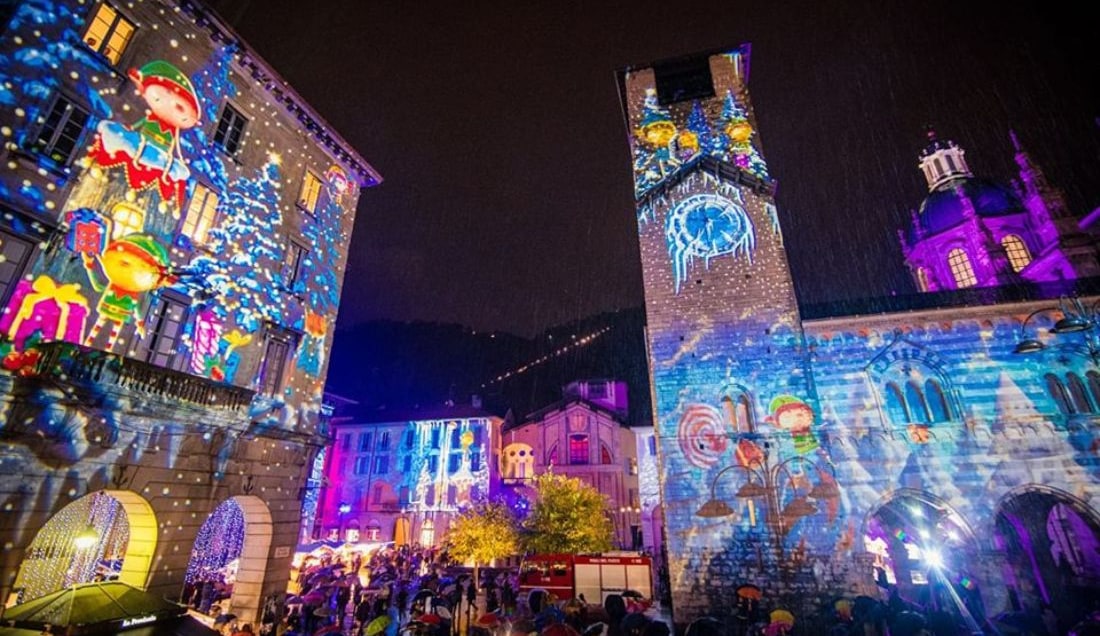 Enjoy views of Como's illuminated buildings after dark.