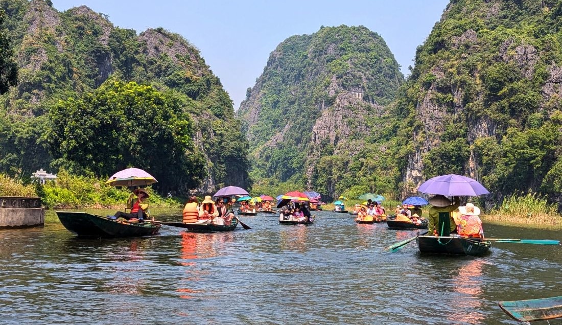 Enjoy a sampan trip along the waterways of Tam Coc.