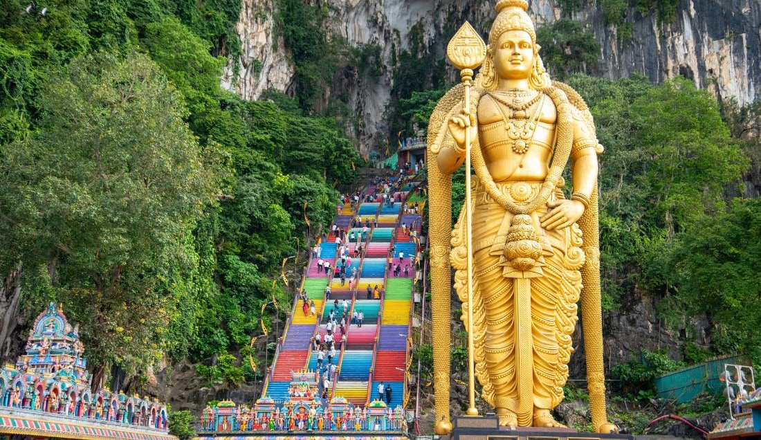 Climb the rainbow stairs at Batu Caves, Malaysia.